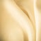 Gold background abstract cloth wavy folds of textile texture