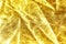 Gold background or texture and shadow. Gold fabric crease