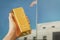 gold bar in the hand of a man against the background of the gold vault of America