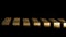 Gold bars in rows on dark background