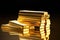 gold bars stacked on a flat surface