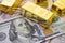 Gold bars on US dollar bill banknotes background. Concept of gold future trading, online asset commodity trading or buy gold bars