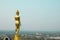 Gold big Buddha stand on hill over Nan city Thailand