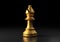 Gold bishop chess, standing against black background
