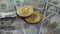 Gold Bit Coin BTC coins rotating on bills of American US dollars.