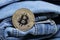 Gold bitcoin and a blue jeans so close