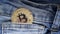 Gold bitcoin and a blue jeans so close