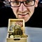 Gold bitcoin coin and man in glasses