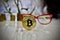 Gold bitcoin coin near pink glasses