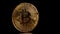 A Gold bitcoin coin rotate on a black background