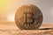 A gold bitcoin coin stands on the surface of Mars in the rays of sunlight. World cryptocurrency