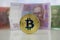 Gold bitcoin coin and Ukraine money