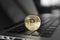 Gold Bitcoin crypto coin on a laptop keyboard. Exchange, bussiness, commercial. Profit from mining crypt currencies