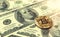 Gold Bitcoin on dollars bills. Macro shot, 3D rendering