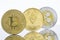 Gold Bitcoin, Etherium and Ripple Tokens in a row