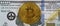 Gold bitcoin on the face of a fake one hundred dollar bill