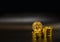 Gold Bitcoin stack on black background.