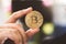 Gold Bitcoins holding in hand, virtual manry and cryptocurrency concept