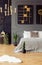 Gold and black painting hanging above bed