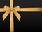 Gold Bow with ribbons. Shiny holiday gold satin ribbon on black