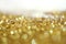 Gold bronze glitter shine dots confetti. Abstract light blink sparkle defocus backgound