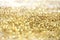 Gold bronze glitter shine dots confetti. Abstract light sparkle defocus backgound
