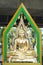 Gold buddha statue with artifact green aura behind