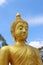 Gold buddha statue with cloudy blue sky