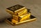 Gold bullion. A stack of gold bars of various weights.