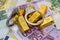 Gold bullions with handcuffs at euro banknotes background