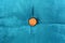 Gold button on blue fabric texture