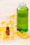 Gold capsules of natural cosmetik for face and bottles with essential oils on the wooden