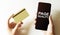 Gold card and phone with text disaster recover plan Page Quality in the female hands