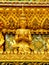 Gold carvings of celestial deities on the walls of kings palace Bangkok