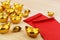 Gold Chinese ingot and Blank red envelopes on wooden background