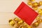 Gold Chinese ingot Yuan Bao and Blank red envelopes on wooden background