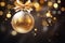 gold christmas glass ball hanging on blurred light background