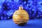 Gold Christmas ornament on blue holiday background. Xmas and New Year