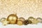 Gold Christmas ornaments with twinkling background