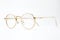 Gold classic round glasses on white background
