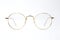 Gold classic round glasses on white background