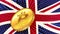 Gold coin of Bitcoin BTC and colored flag of Great Britain on background. Central Bank of England adopts laws on mining and