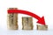 Gold coin stacks icon in shape of diagram. Red arrow going down. Economy decline business concept