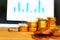 Gold coins, gold bars, sorting, concept, saving, education, gold investment  Forex trading, stock table background blur