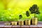 Gold coins pile stack and growing money and grow trees that grow up on nature background, Saving money and ecology concept