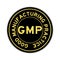 Gold color of word GMP on black round sticker on white background