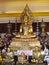 Gold-colored Buddha and monks statue in Buddhist temple