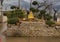 Gold colored statue of a Nyorai Buddha surrounded by deer at the Buddhist Center of Dallas, Texas.