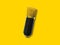 Gold condenser microphone isolated on yellow background