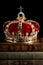 A Gold Coronation Crown with Red Velevet on a Stack of Old Books